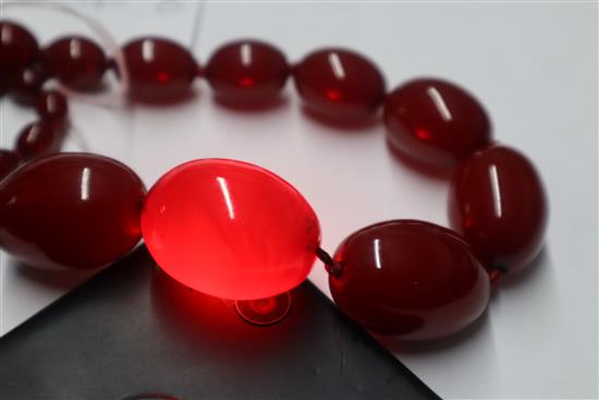 A single strand graduated simulated cherry amber necklace, gross weight 95 grams,